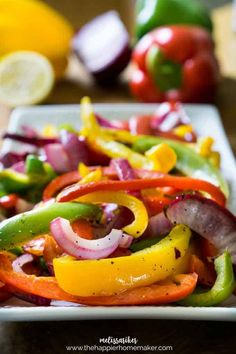 a white plate topped with bell peppers and onions