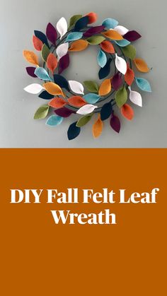 a wreath made out of felt leaves on a wall