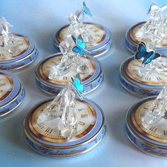 six clocks with blue butterflies on them sitting next to each other