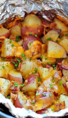 potatoes and bacon are cooked in foil on the stove top, with green garnish