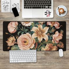 a desk with a keyboard, mouse and flowers on it next to a cup of coffee