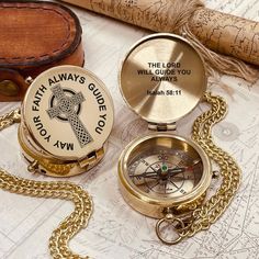 two personalized pocket watches sitting on top of a map