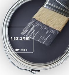 a paint can with a brush in it and the words black sapphire painted on it