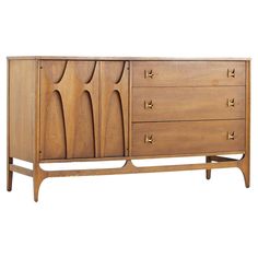 the sideboard is made from wood and has three drawers, two doors and one drawer