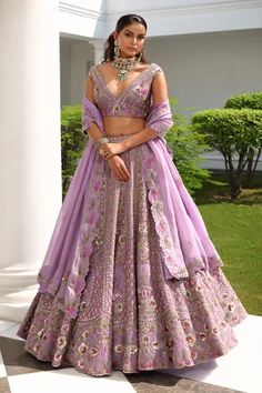 Lavender A-line flare lehenga, accentuated with all over sequin, cutdana, beads and crystal embellishments in floral bloom pattern. Paired with a plunging V neckline blouse, highlighted with all over floral bloom embroidery in sequin embellishments. Comes with a scallop trim cutwork dupatta.
Component: 3
Pattern: Hand Embroidered
Type Of Work: Sequin,Flower,Cutdana,Beads,Crystals
Neckline: Plunging V Neck
Sleeve Type: Sleeveless
Fabric: Silk, Satin Organza
Color: Purple
Other Details: 
Four side Purple Lehenga Bridal, Lavender Lehenga, Engagement Dress For Bride, Purple Lehenga, Heavy Lehenga, Chic Prom Dresses, Organza Lehenga, Floral Lehenga, Indian Outfits Lehenga