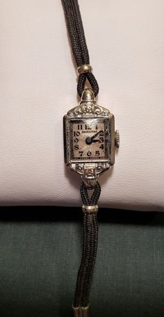 This is a stunning, dainty, Hamilton ladies wrist watch from the 1930's. It has a solid 14KT white gold bezel and case, the bezel also has two beautiful diamonds. The watch has the original gold plated band. It has 17 jewels. The hands move and the watch winds but it is not currently ticking. It will need to be serviced if planning to wear as a timepiece.  Very special vintage watch in wonderful vintage condition. I love finding and restoring, to the best of my ability, antique and vintage items Luxury Vintage Jewelry And Watches With Polished Finish, Luxury Antique Rectangular Watch, Luxury Vintage Evening Watches, Luxury Antique Watch Accessories, Luxury Victorian Engraved Watch, Vintage Watch Chaika, Cheap Vintage Watch Accessories For Women, Luxury Vintage Watch Bracelet Strap, Luxury Antique Self-winding Watch