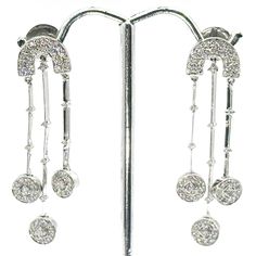 18 Kt white gold diamond hanging earrings. These beautiful earrings contain 3 rows of round shape natural diamonds with a total weight of 2.00 Ct. The diamonds are rated F color and VS2 clarity. The earrings measure 1.75 inches in length and 0.50 inches in width.  The total weight of the earrings 10.0 g Original Price: $7,900.00 Your Price: $2,300.00 You Save: $5,600.00 Diamond Hanging Earrings, Hanging Earrings, Body Jewellery, Diamond Fashion, White Gold Diamonds, Round Shape, Beautiful Earrings, Body Jewelry, Favorite Jewelry