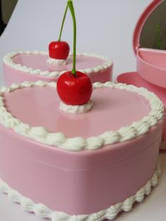 two pink heart shaped cakes with cherries on top