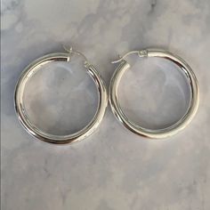 Sterling Silver 925 Plated With Rodium Hoop Earrings Thicker Hoop Round Hoop Earrings New Never Worn Smoke Free Home Last Picture For Size Modern Silver Hoop Earrings With Sterling Clasp, Classic Sterling Silver Hoop Earrings For Pierced Ears, Shiny Round Hoop Earrings For Anniversary, Round Hoop Earrings With Shiny Finish For Anniversary, Round Shiny Hoop Earrings For Anniversary, Everyday Sterling Silver Hoop Earrings With Shiny Finish, Silver Hoop Earrings With Polished Finish, Sterling Silver Hoop Earrings With Shiny Finish, Silver Huggie Earrings With Shiny Finish