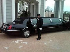 a man standing next to a black limo