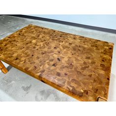 a wooden table that has been made out of wood and is sitting on the floor