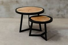 two tables made out of wood with black legs and one has a wooden slice on top