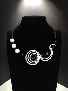 Modern style choker necklace created using silicone components and resin and glass beads. The necklace is rigid and asymmetrical, it sits perfectly on the neck. The closure is adjustable with a stainless steel carabiner and a 5 cm extension. This necklace is in black and white which makes it very elegant, perfect for an evening dress. For those who love an unusual and modern style. All jewels are delivered in a decorated box, ready to be given as a gift to your loved one. How to take care of your jewellery: put on your beauty products (cosmetics, perfumes, ...) before wearing your precious jewel. Clean your jewelry with a soft cloth after wearing. Don't use water. Make sure you store your jewelry separately to avoid scratching it. Store away from heat sources, in a dry place in the special Unique White Choker Necklace, Unique White Choker, Artistic White Necklace With Unique Variations, Modern White Adjustable Necklace, Black And White Necklace, Summer Choker, Silicone Necklace, Black And White Necklaces, Art Nouveau Necklaces