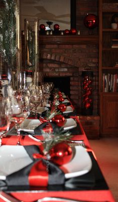 a long table is decorated with red and black christmas decorations