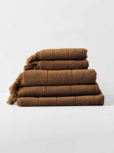 four brown towels stacked on top of each other