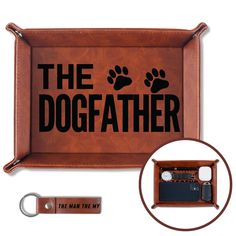 the dogfather leather tray with keychain is shown next to an electronic device