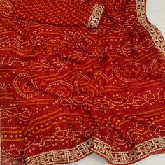 Red color saree is made from chiffon is highlighted with beautiful foil printed with printed with embroidered border work as shown. Comes along unstitched embroidered banglori silk blouse piece which you can customise as per your design/style. Occasion - You can wear this saree for festive and functions. Note:- The actual product may differ slightly in color and design from the one illustrated in the images when compared with computer or mobile screen. Measurements: Saree : Chiffon : 5.5 Mtrs Blouse : Chiffon : 0.8 Mtr Material: Chiffon Stitch Type: Unstitched Country of Origin: India Care Guide: Dry Clean Red Pre-draped Saree With Embroidered Border For Festivals, Festival Georgette Pre-draped Saree With Printed Border, Navratri Georgette Blouse Piece With Printed Border, Festival Red Georgette Blouse Piece, Bollywood Style Blouse With Printed Border For Navratri, Red Blouse Piece With Embroidered Border For Eid, Bollywood Georgette Traditional Wear With Printed Border, Red Georgette Blouse Piece For Navratri, Traditional Red Georgette Blouse Piece