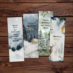 four christmas cards on a wooden table