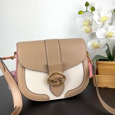 100% Coach Authentic Guarantee! Product Details Refined Pebble Leather And Smooth Leather Inside Multifunction Pockets Snap Closure, Fabric Lining Outside Open Pocket Detachable Strap With 20 3/4" Drop For Shoulder Or Crossbody Wear 8 1/4" (L) X 6 3/4" (H) X 2 3/4" (W) Style No. C3596 Chic Leather Shoulder Bag With Color Block, Trendy Beige Coach Bag, Chic Beige Color Block Bags, Chic Coach Crossbody Saddle Bag, Chic Leather Color Block Shoulder Bag, Chic Leather Color Block Bag, Coach Beige Shoulder Satchel, Coach Saddle Bag With Gold-tone Hardware, Coach Leather Saddle Bag With Gold-tone Hardware