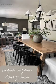 a dining room table with chairs and a vase on top of it in front of a couch