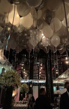 balloons are hanging from the ceiling at a party