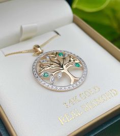 14K Gold Tree of Life Pendant, a stunning piece of Irish jewelry that showcases the iconic Tree of Life design. Decorated with shimmering diamonds and emeralds, this pendant is a luxurious addition to any collection. Whether you're looking for a special gift or a beautiful piece to add to your Irish jewelry collection, the 14K Gold Tree of Life Pendant is an excellent choice. Whether you're treating yourself or searching for the perfect gift, this pendant is sure to impress. Height: 0.91″ Width: 0.91″ Weight: 3.81g Gemstone: Diamonds and Emeralds Diamond color: I-J Diamond clarity: I1-2 Chain not included (optional) Hallmarked at the Assay Office Handmade in Dublin, Ireland Tree Of Life Design, Celtic Pendant, Celtic Tree Of Life, Irish Jewelry, Gold Tree, Tree Of Life Pendant, Dublin Ireland, Life Design, Diamond Color