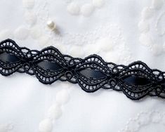 black lace on white fabric with buttons