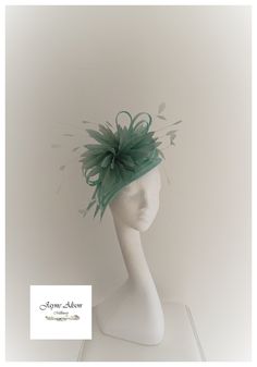 'Striking, elegant headpiece in mint green, sea green, sage green  sinamay.  Inspired by the 'bird of paradise' flower. This dramatic headpiece is made of 3 separate  petals with elongated tips.  An abundance of sage goose feathers protect a central bow, green coq feather tips dance in the breeze.    Sits on a headband 'This item has sold, however, similar pieces can be made in a variety of colours.  Please ask for details.  As every piece is handmade, some differences can occur from the photos Green Summer Costume Hats And Headpieces For Church, Green Mini Hats For Spring Church Occasions, Green Mini Hats For Church In Spring, Turquoise Headpiece For Summer Wedding, Green Formal Headpiece For Kentucky Derby, Turquoise Headpieces For Summer Weddings, Elegant Green Headpiece For Church, Elegant Turquoise Hat For Spring, Turquoise Summer Wedding Headpiece