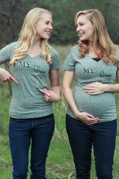 two pregnant women standing next to each other