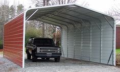 a truck is parked in front of a metal carport attached to the side of a building