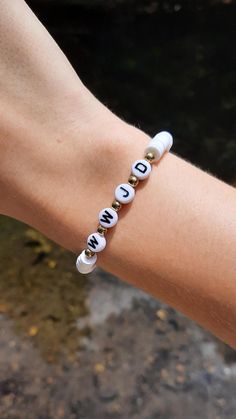 This super cute clay bead bracelet is made with high quality beads. It has all white clay beads with the letters "WWJD" in the center. the letters are separated by circular gold accent beads. Please note that colors and pattern may vary from each bracelet. All bracelets vary from 6.5 inches to 6.75 inches.  While the string I use is high quality, be careful not to overstretch the bracelet as it will shorten its lifespan. In addition, keep out of water as it will shorten the lifespan of the bracelet. Excessive sweating and water exposure may also rust any gold beads if there are any gold beads on the bracelet.  WARNING: keep out of reach of children as this product is a choking hazard. 🚨HOW TO GET BUY 4 GET ONE FREE: 🚨 -add 4 items to your cart -when you go to check out you will see "+ a Mexican Bracelets Clay Beads, Clay Bead Bracelet For Teacher, Quotes To Put On Bracelet, Flat Bead Bracelet Ideas Words, Small Business Bracelet Ideas, Clay Bead Bracelet Ideas Wwjd, Cross Clay Bead Bracelet, White And Gold Clay Bead Bracelet, Bread Bracelet Ideas