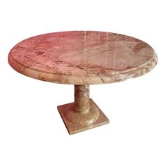 a round marble table sitting on top of a wooden base