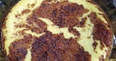 a cake that is sitting in a pan on the stove top with some brown stuff around it