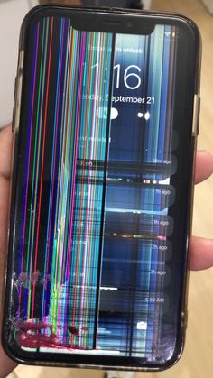 someone is holding up their cell phone with colorful lines on the screen and back cover