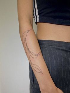 a woman's arm with a tattoo on the left side of her body,