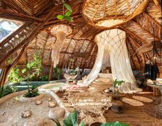 the inside of a hut with lots of plants and decorations on it's walls