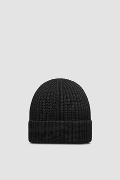 A staple design in a casual wardrobe, this beanie is crafted from cotton and embellished with a Matt Black logo patch. Cotton Knitted Hats For Streetwear, Knitted Cotton Hats For Streetwear, Black Cotton Knitted Beanie, Classic Black Wool Beanie, Casual Wool Beanie, Black Wool Beanie Cap, Urban Black Beanie For Streetwear, Classic Cotton Winter Hat, Casual Wool Hat With Embroidered Logo