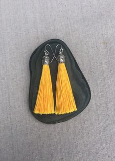 "Chic yellow tassel earrings! They would add a pop of color to any outfit for any occasion. Dress them up or down. They are timeless and versatile. They are lightweight, fun and unique! The tassels measure 2 1/8\" long by 1/4\" wide. They hang from simple silver ear wire hooks. Overall drop length is about 2 1/4\". Metal is allergy free plated silver. These are my latest creation! I have them available in many colors! Find them all under the category tassel earrings in my shop. Thanks for stoppi Yellow Fringe Earrings As Gift, Orange Tassel Earrings Gift, Yellow Dangle Tassel Earrings Gift, Yellow Tassel Earrings As Gift, Orange Fringe Earrings As A Gift, Orange Fringe Earrings As Gift, Yellow Statement Earrings, Yellow Tassel Earrings, Acorn Jewelry