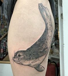 a sea lion tattoo on the right thigh