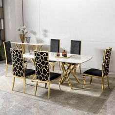 a dining room table with chairs and a rug