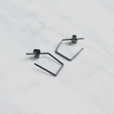 "The earrings are shaped from a silver wire of 1mm to create these delicate Polygon hoops. The clean lines of this geometric jewelry looks very simple, yet so stylish and modern. Minimalist and light weight, you can truly wear these hoops with any outfit and they will look beautiful! Available in matte, shiny or black oxidized finish. DIMENTIONS Length 22mm Width 15mm Post of 19 gauge wire // 1mm diameter This listing is for one pair of earrings including ear backs. ------ HIGH QUALITY We create Jewelry Looks, Geometric Jewelry, Soft Towels, Support Handmade, Geometric Earrings, Recycled Sterling Silver, Artisan Craft, Light And Shadow, Silver Wire