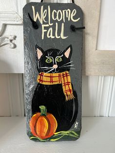 a welcome fall sign with a black cat