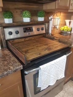 a kitchen with an oven and counter tops made out of wooden planks on top of the stove