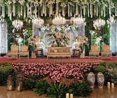 an elaborately decorated room with chandeliers and flowers