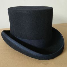 Welcome to our standalone platform, where timeless elegance meets sophistication - the Top Hat. Whether for formal occasions or personal style statements, this classic high-crowned hat is your ultimate choice. Ensure to order your regular hat size, as these hats fit true to size with more than enough room for comfort. Experience Elegance: Theater Quality Men's Top Hat Elevate your formalwear with our meticulously crafted men's top hat, designed for serious collectors and lovers of sophisticated style. Indulge in the theater-quality experience brought to you by the 100 percent wool felt body and smooth leather sweatband, making this top hat a must-have for those who appreciate the finer things in life. Timeless Tradition: Traditional Style Redefined Immerse yourself in the elegance of an ea Top Hat, Formal Occasion, Hat Sizes, Sophisticated Style, Formal Wear, Smooth Leather, Traditional Style, Timeless Elegance, Wool Felt