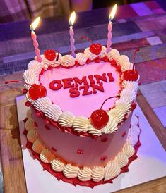 a heart shaped cake with candles on it and the word omni is spelled in red