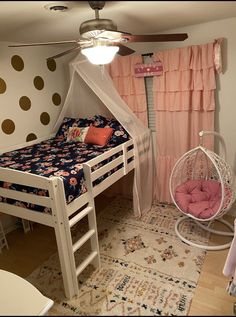 a bedroom with bunk beds and a hammock chair in the corner next to it