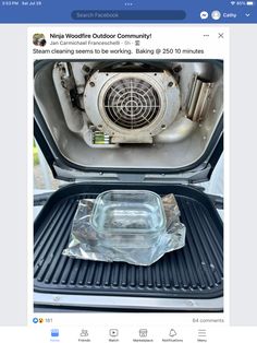 the inside of an open car trunk with a glass dish on it's side