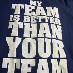 Blue Shirt White Lettering Navy Team Spirit Tops With Letter Print, Blue Team Spirit T-shirt With Text Print, Blue Tops With Text Print For Game Day, Blue Text Print Top For Game Day, Navy Team Spirit Tops With Graphic Print, Blue Tops With Text Print For Team Spirit, Navy Graphic Print Sports Team Themed Top, Navy Graphic Print Top With Team Spirit Style, Navy Graphic Print Tops For Team Spirit