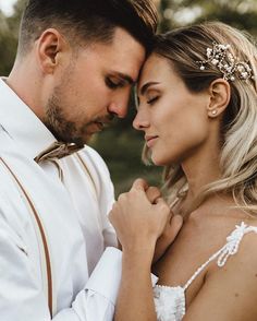 a man and woman standing next to each other with their hands on their chests